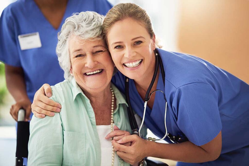 Older adult and family member reviewing care options at a table with a caregiver nearby.